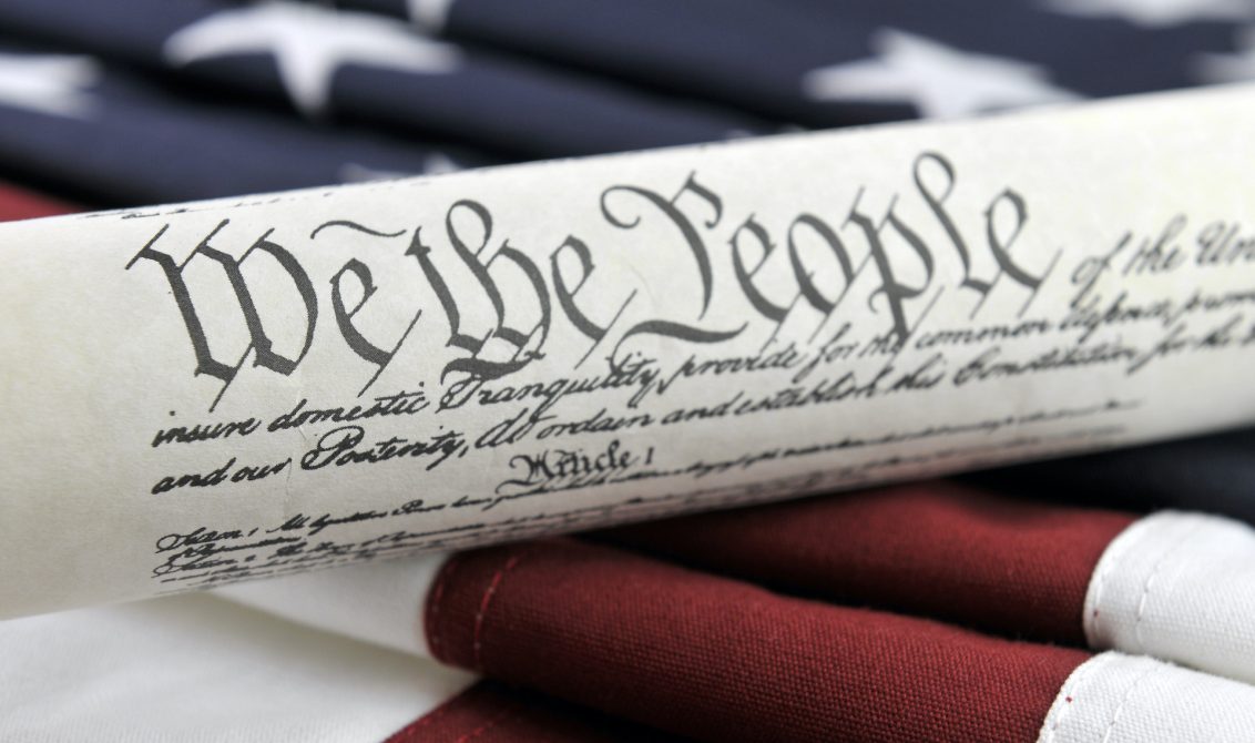 Photo: U.S. Constitution and American Flag | Credit: Justasc, YFS Magazine, Adobe Stock