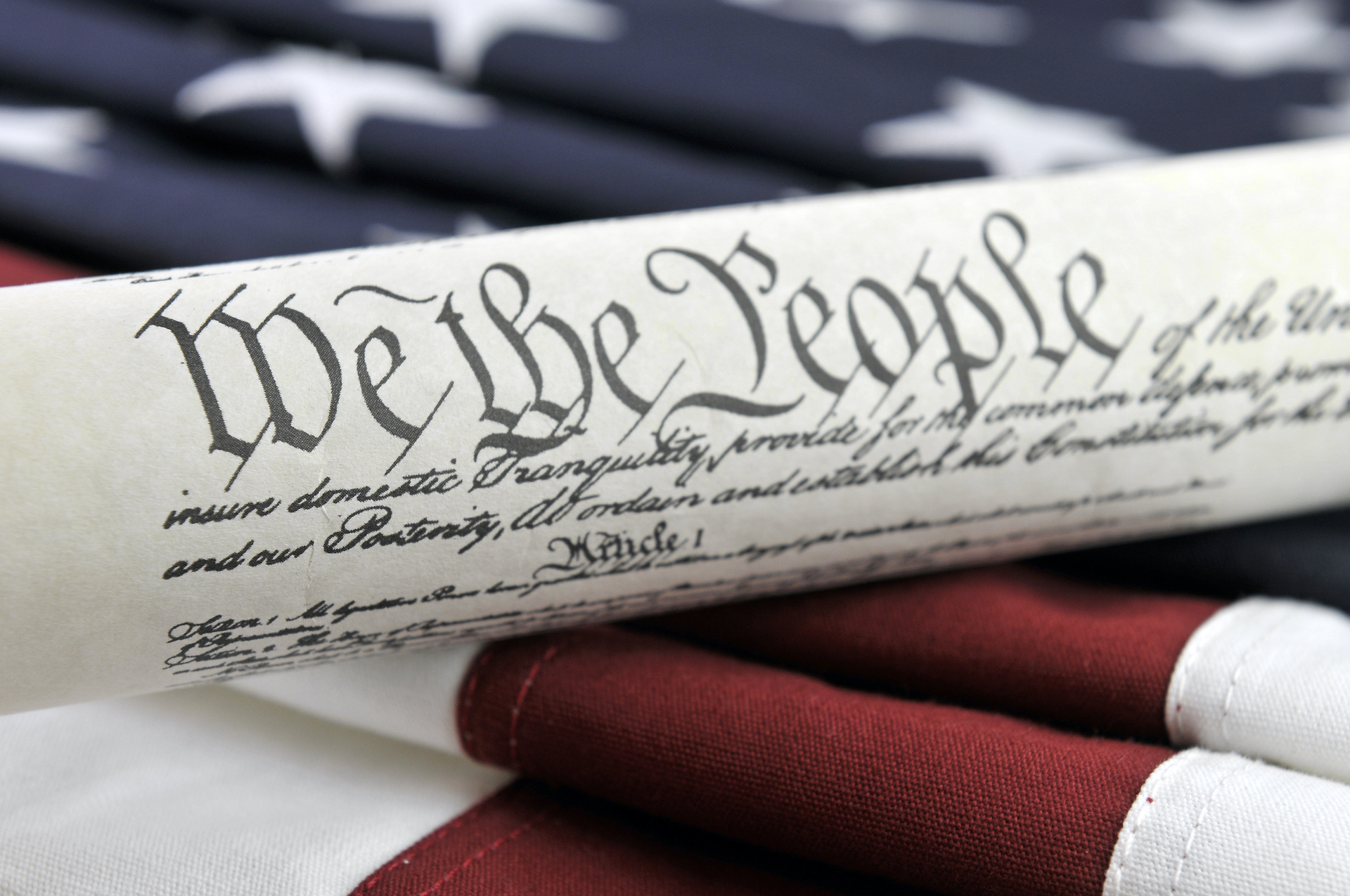 Photo: U.S. Constitution and American Flag | Credit: Justasc, YFS Magazine, Adobe Stock